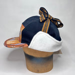 Vinterkeps 58-59cm - svart bomullscanvas, orangemönstrat